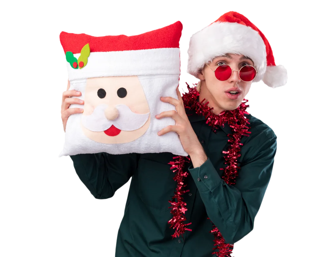 Man in a Santa hat carrying a Santa-face cushion