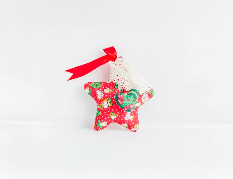 Red patterned fabric star ornament with a ribbon bow