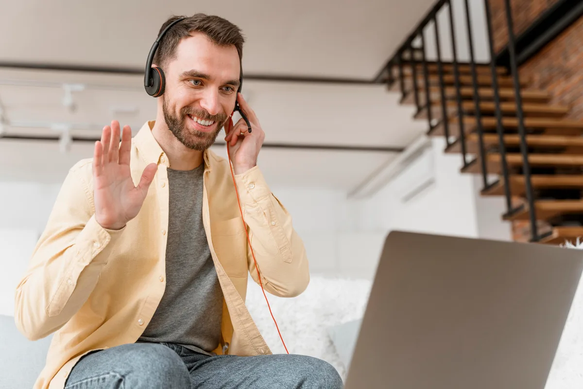 Instructor waving to students during an online class