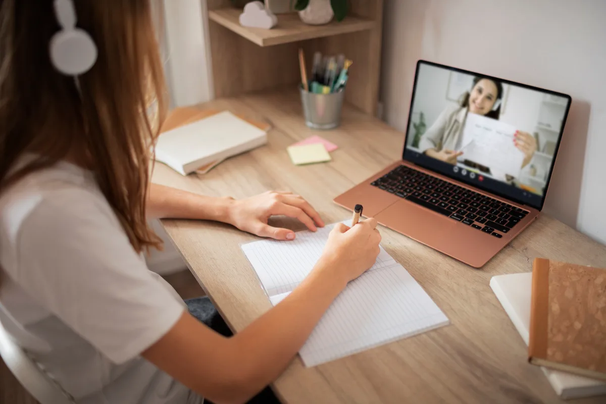 Laptop screen showing a live class with the instructor on camera