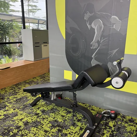 An adjustable weight bench and kettlebell against a graphic gym wall