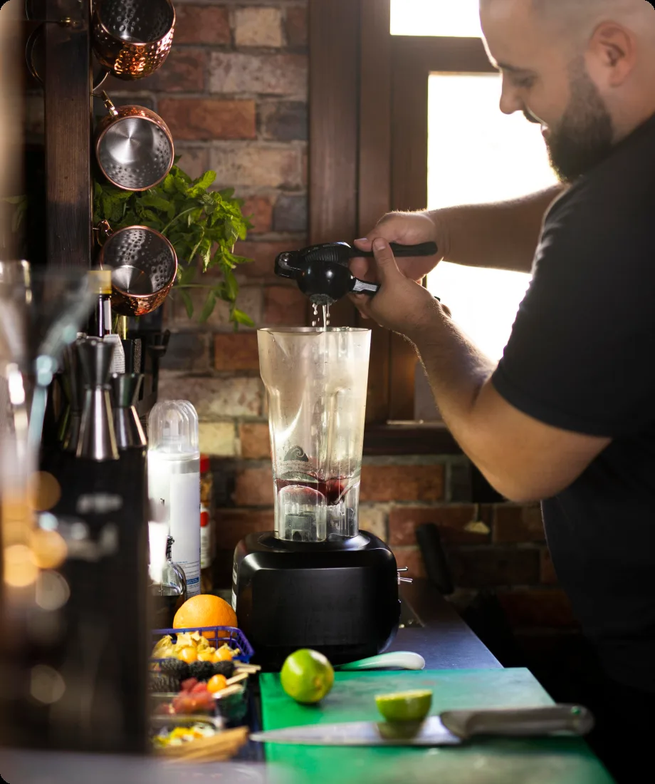 A bartender blending a fresh protein shake at the FORGE sport bar