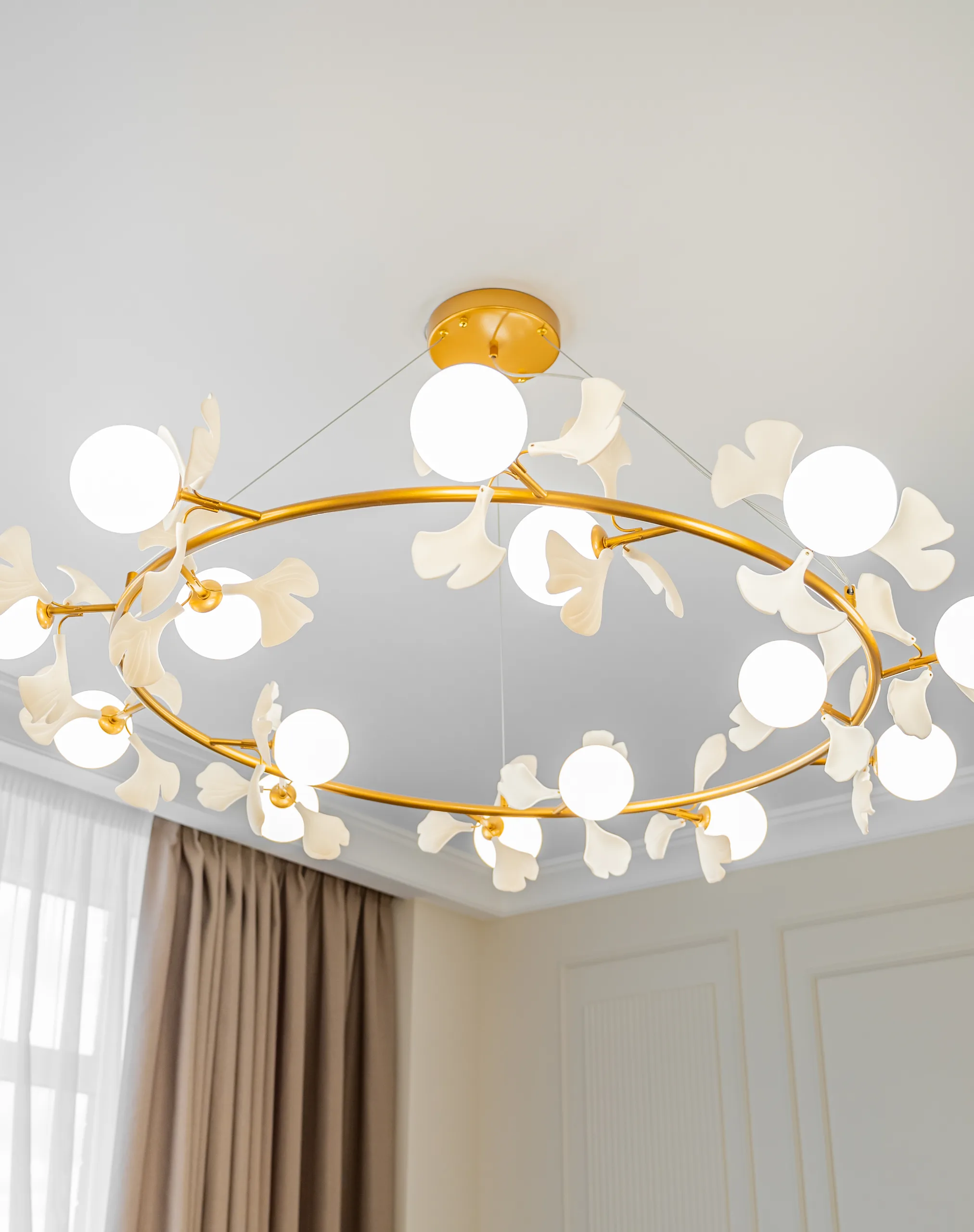 Brass branch chandelier with white glass blossoms