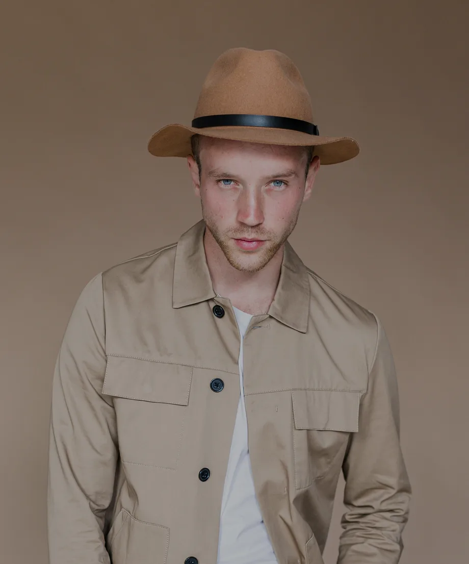 Man in a camel wool fedora with a black band