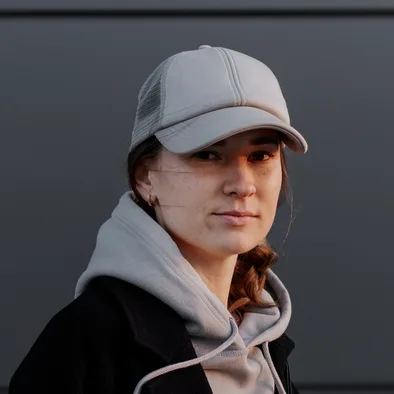 Person in a white baseball cap and grey hoodie