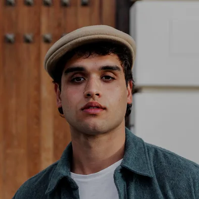 Man in a beige flat cap and a denim shirt