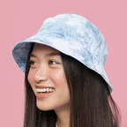 Woman smiling in a blue tie dye bucket hat