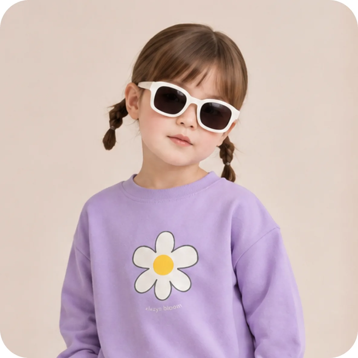 Girl in a lilac daisy sweatshirt wearing white sunglasses
