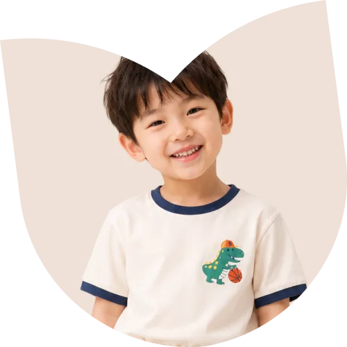Boy in a cream dinosaur T-shirt with navy trim