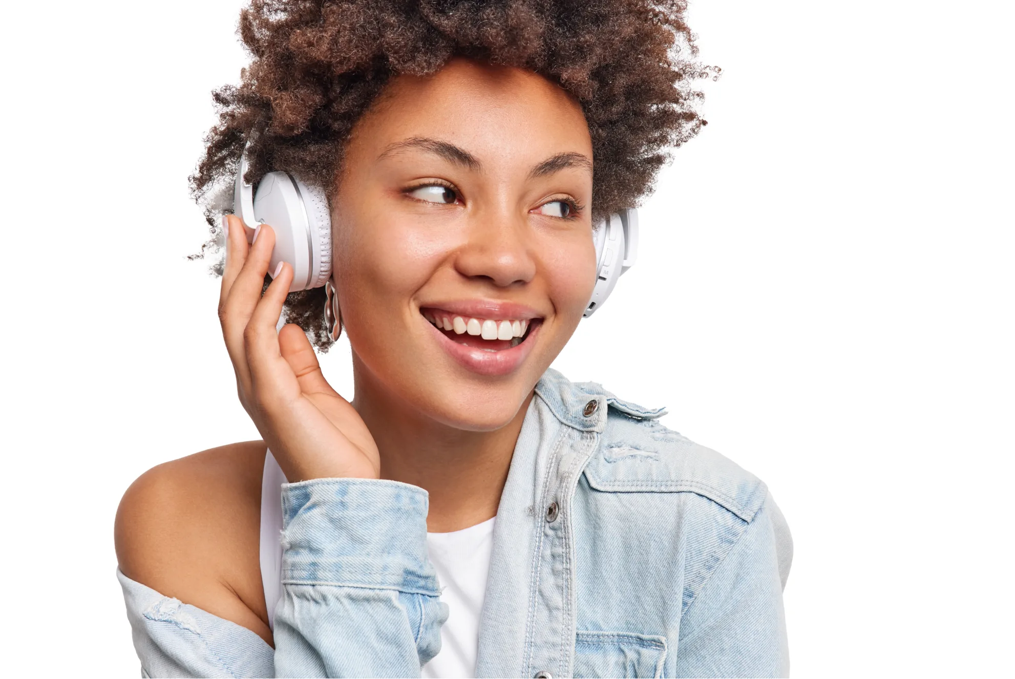 A smiling woman wearing white over-ear headphones