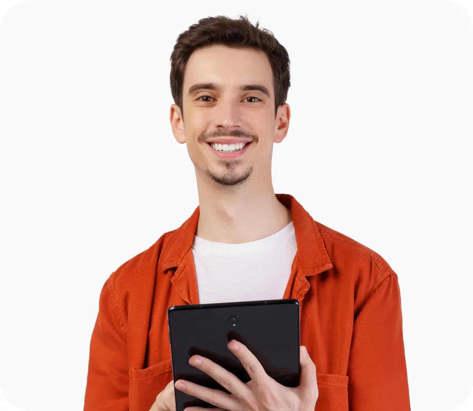 Smiling man in an orange shirt holding a tablet