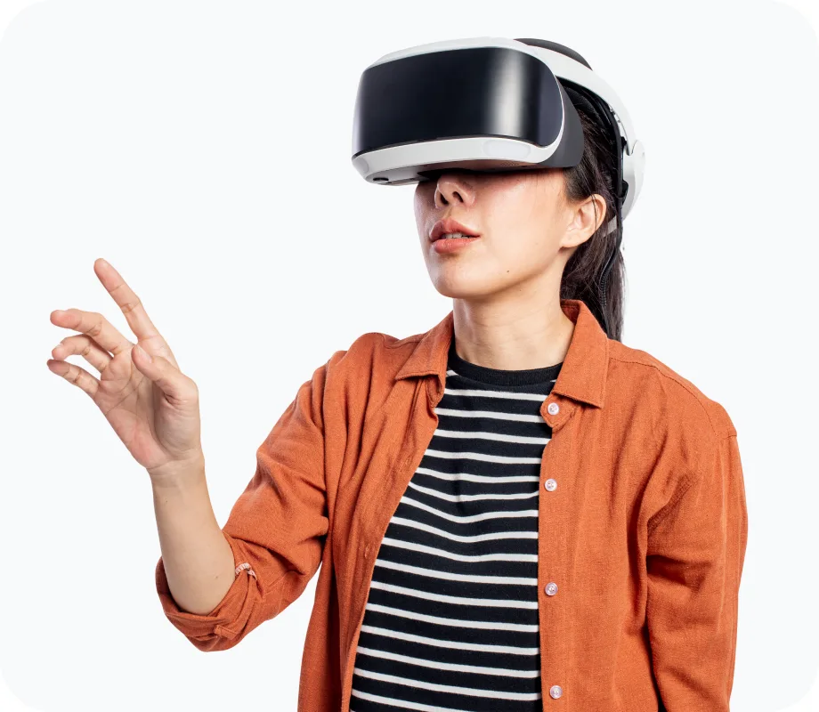 Woman in an orange shirt wearing a white virtual reality headset