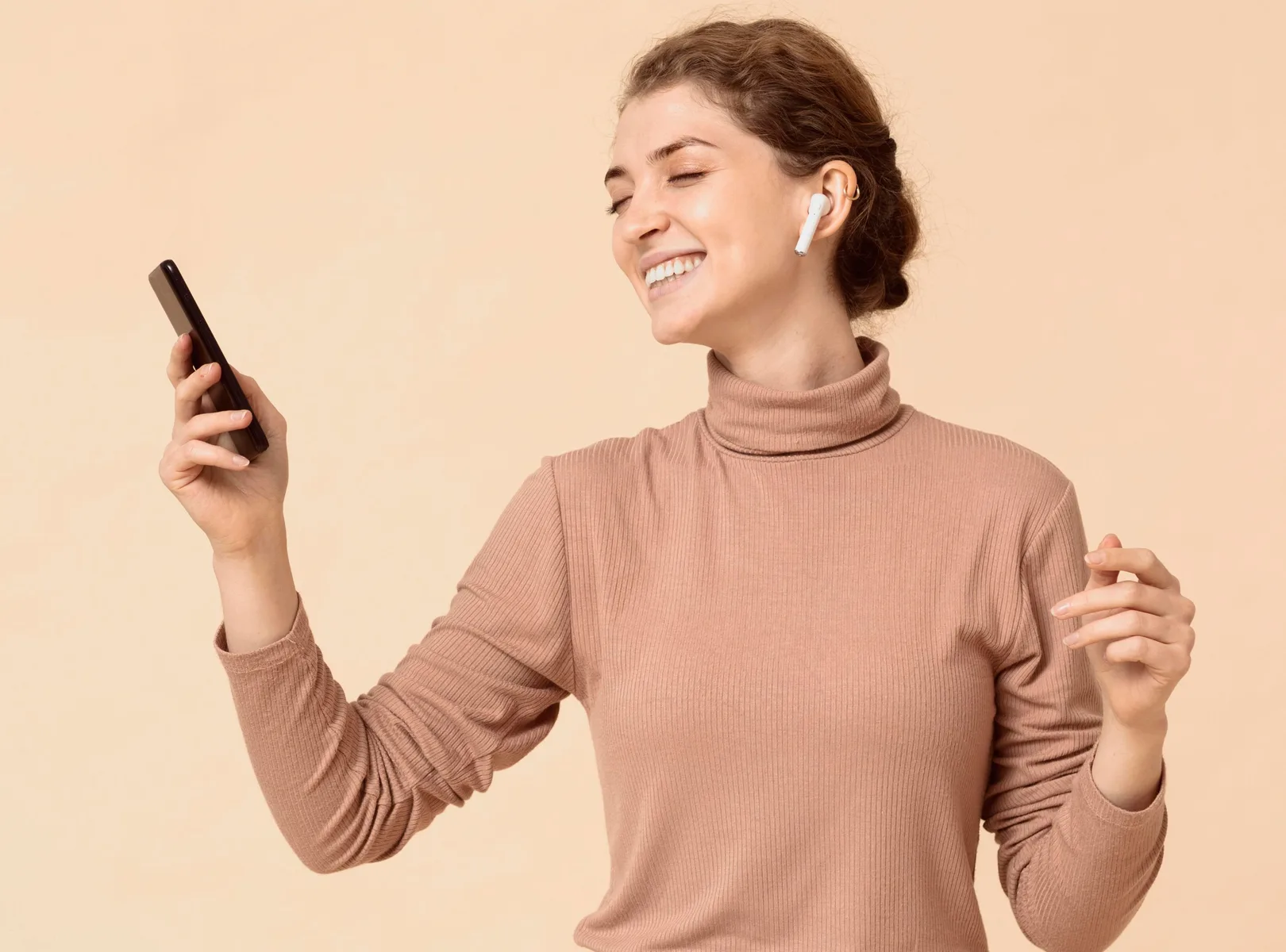 Woman listening to music through a wireless earbud