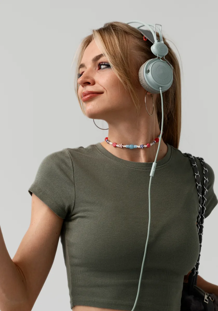 Customer wearing sage green wireless headphones