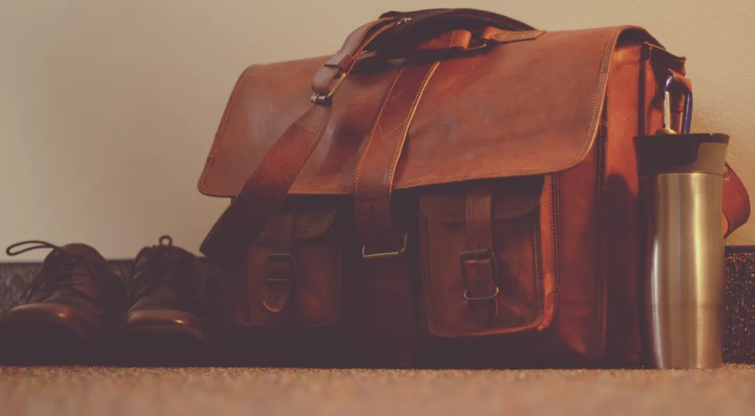 Packing cubes and a rolled rain shell laid out beside an open cabin bag